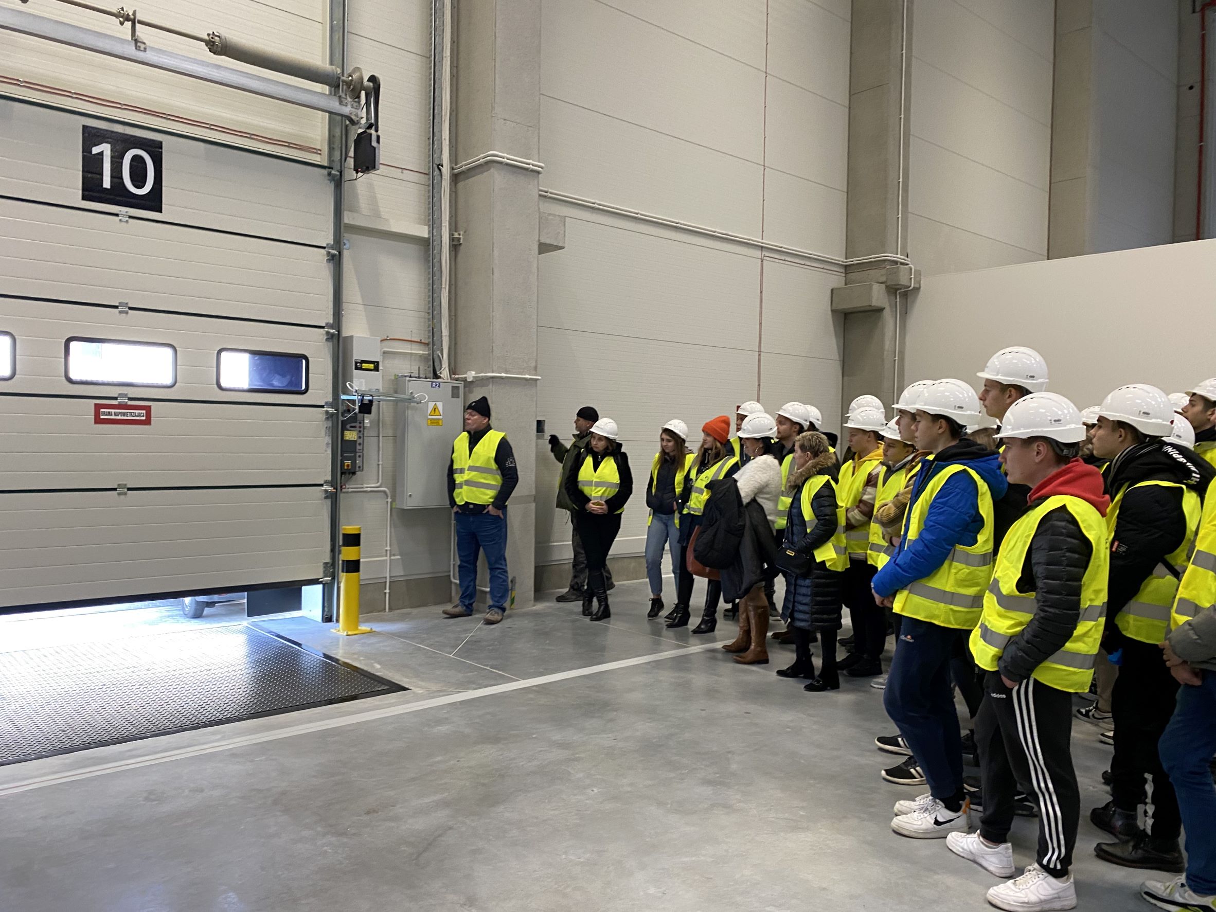 students in the warehouse looking at the dock gate opens