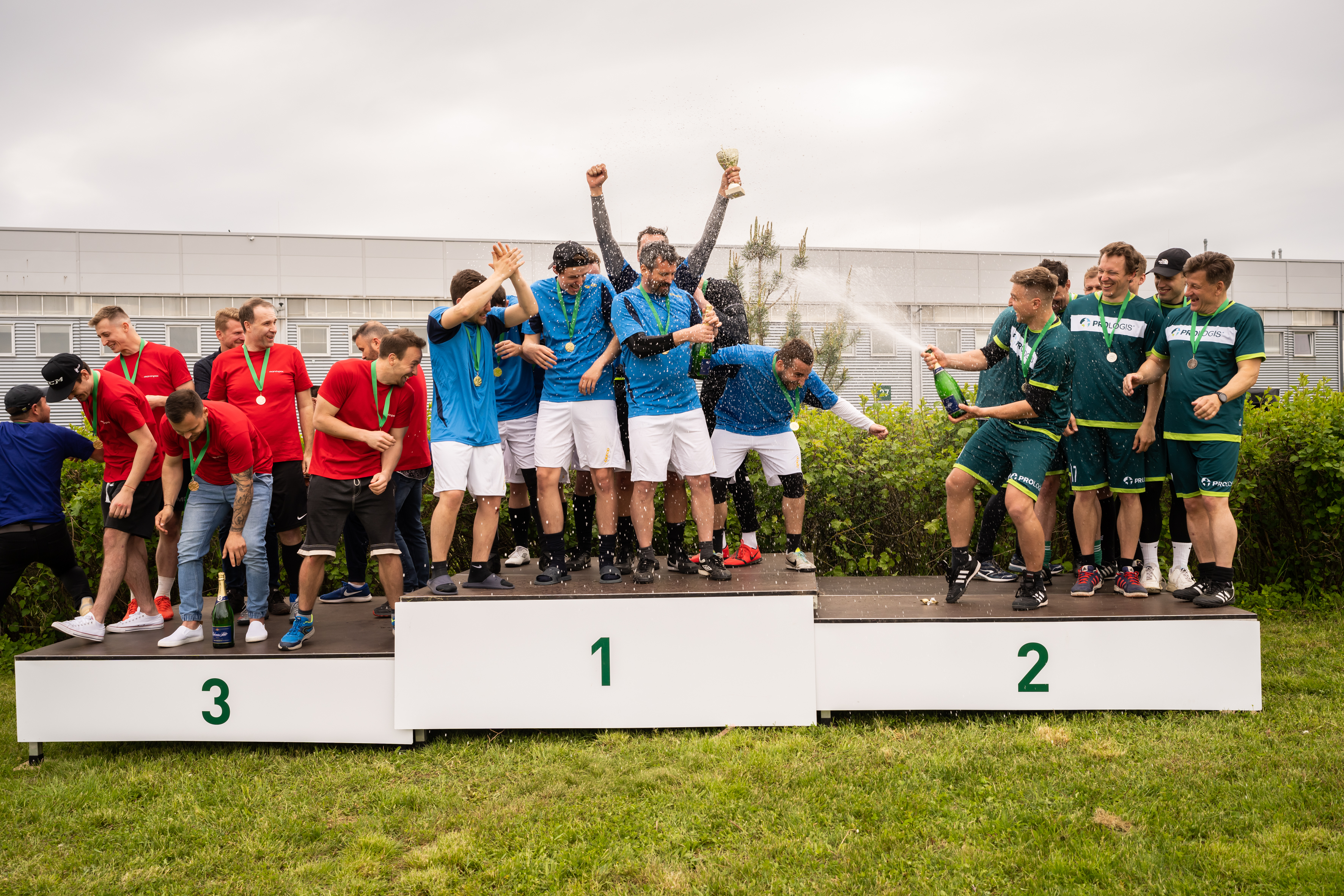 3 football teams on podium