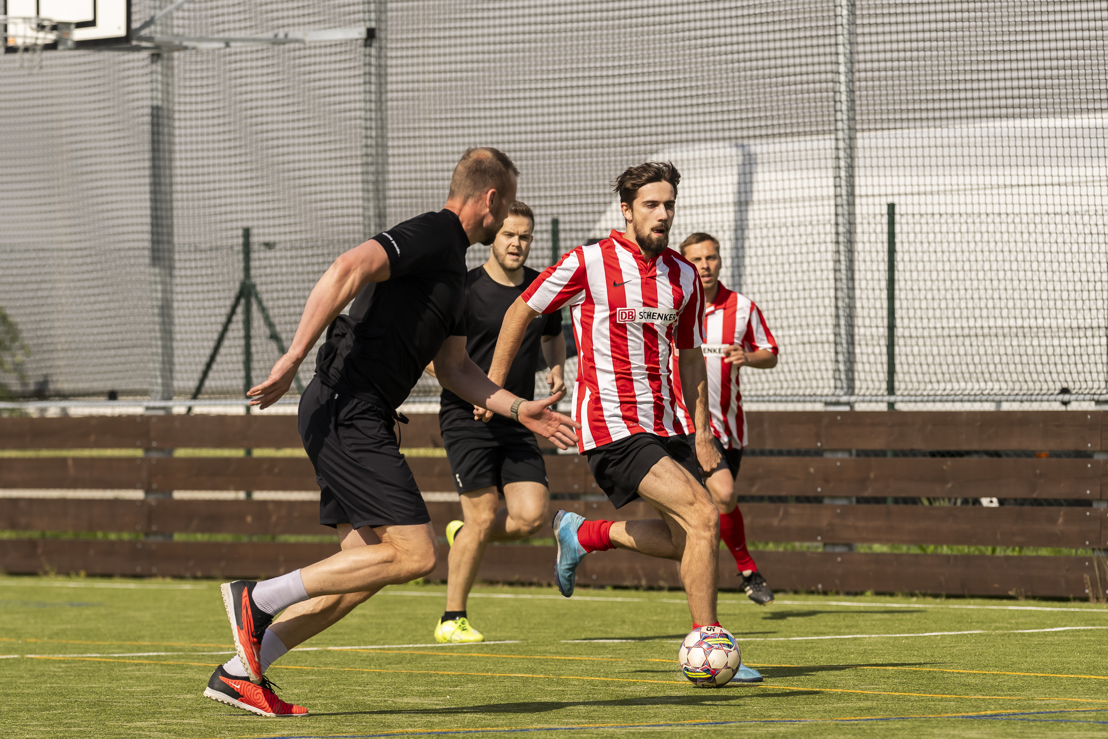 4 men playing football