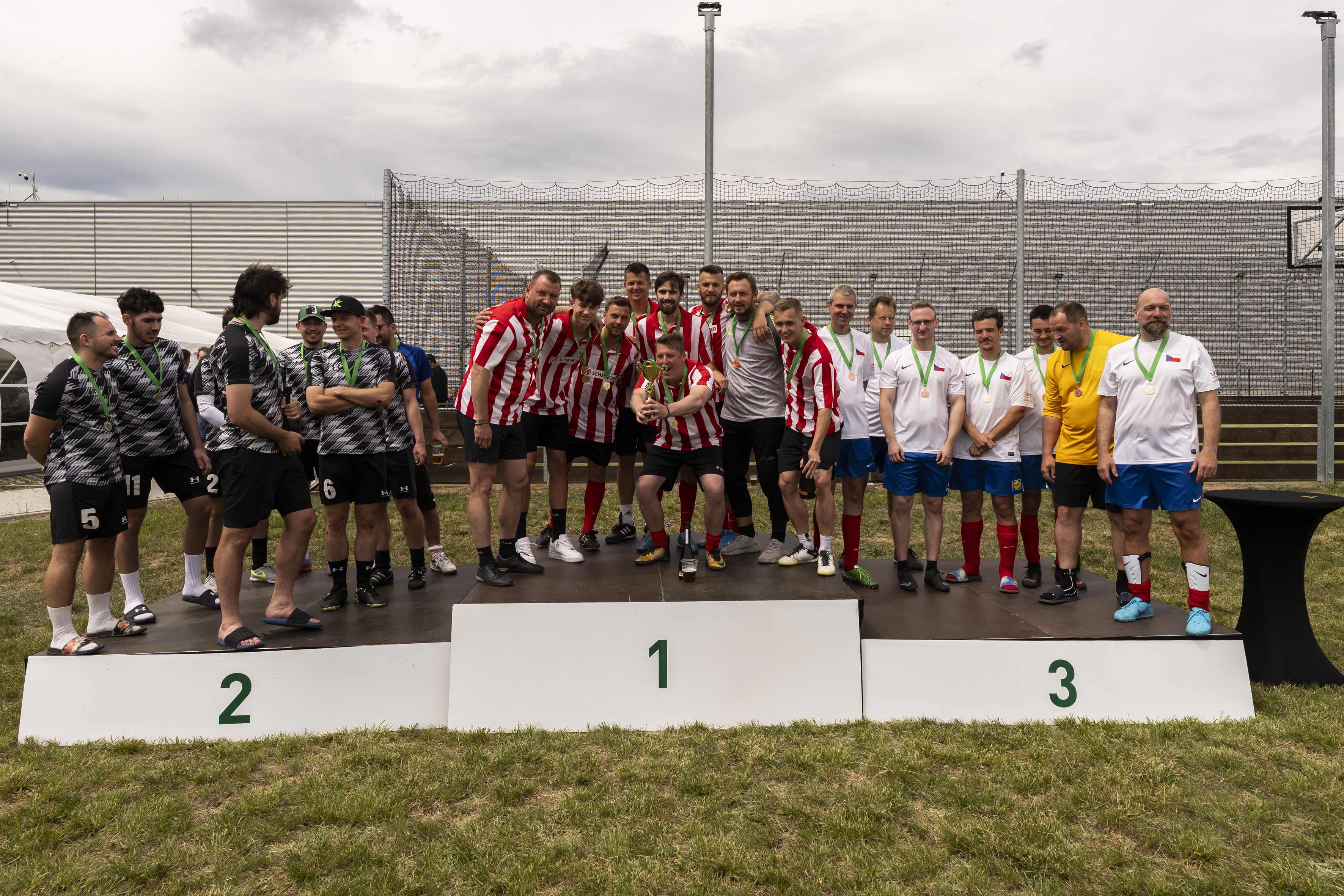 3 football teams on the podium