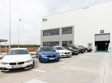 warehouse building with six cars outside