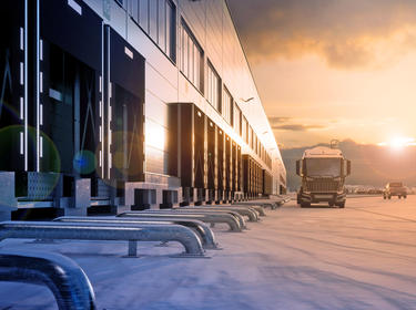 photo showing warehouse, dockdoors and truck in the distance