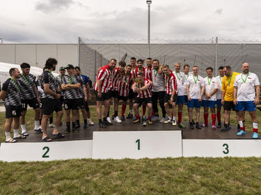 3 football teams on podium